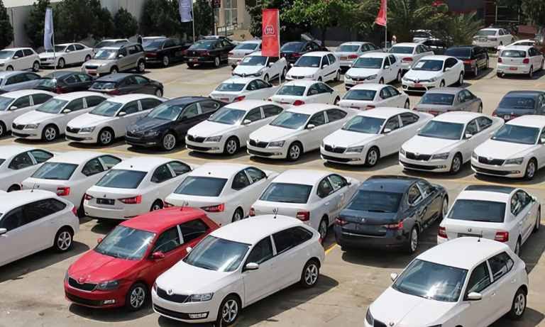 Rows of new cars parked in an open-air lot, file photo