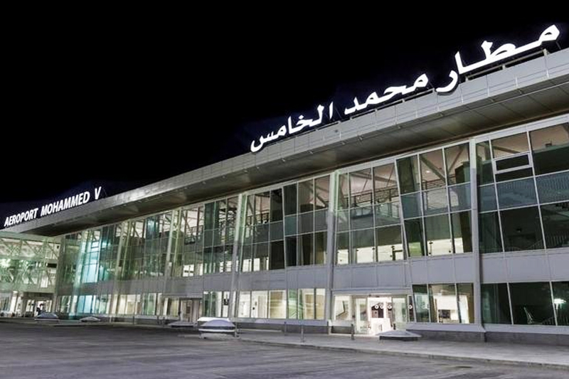 The Mohammed V airport terminal facade at night, with its name in Arabic and French, file photo