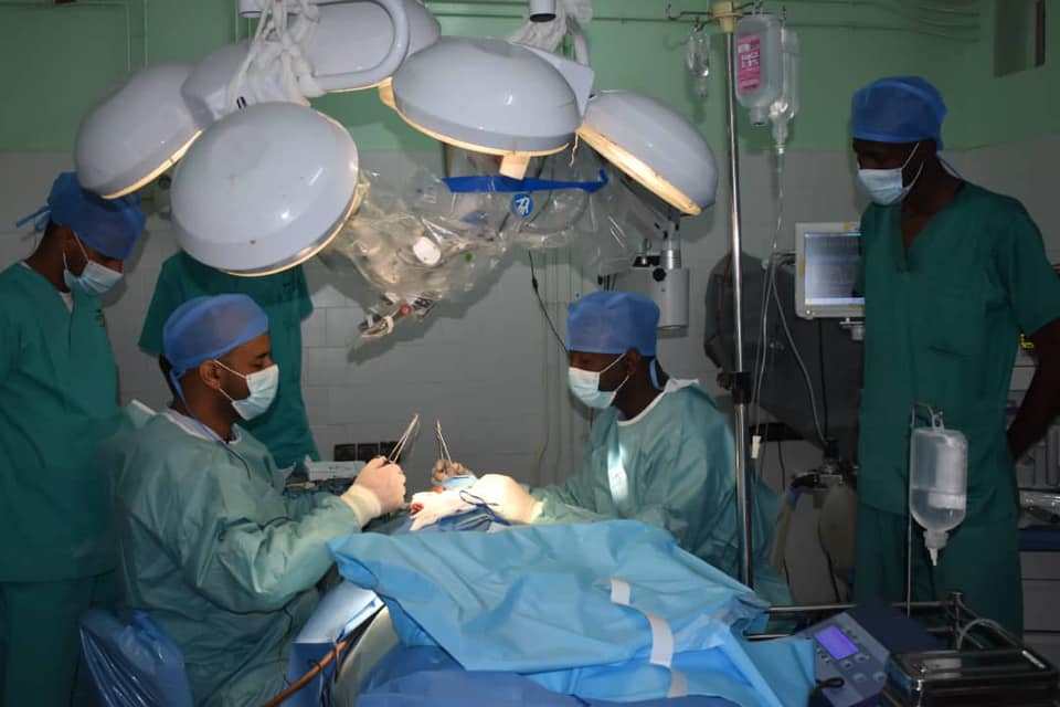 A medical team in surgical gowns operates in an operating theatre in Nouakchott