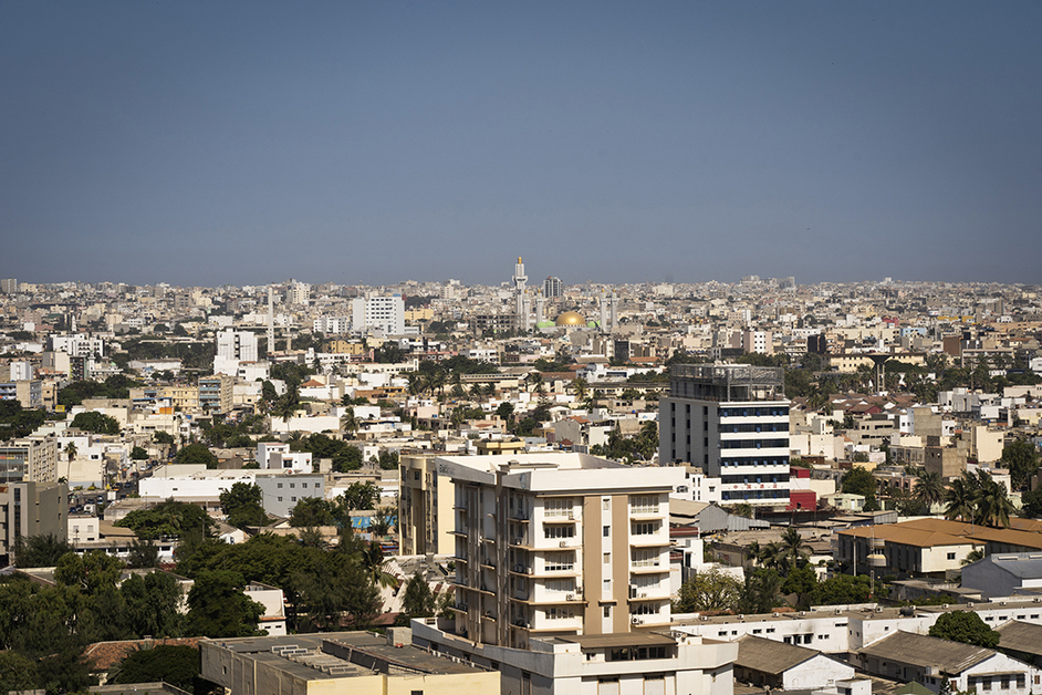 Elevated view of Dakar's white buildings with a golden mosque dome in the middle under a clear sky, file photo