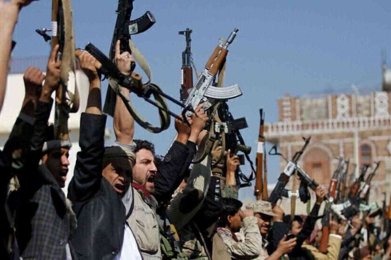 Armed men raising their rifles at a rally of Houthi supporters in Sanaa, file photo