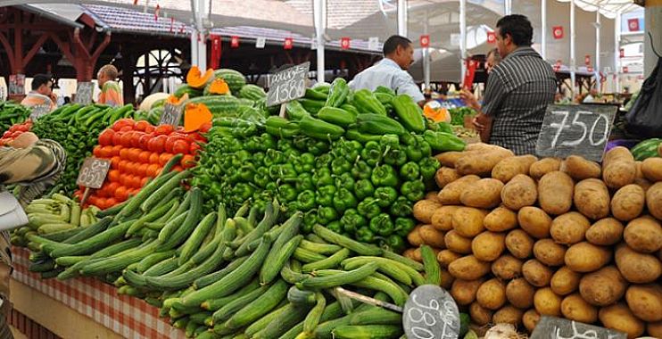 A vegetable stall in a Tunisian market with peppers, courgettes, tomatoes and potatoes and price boards, file photo