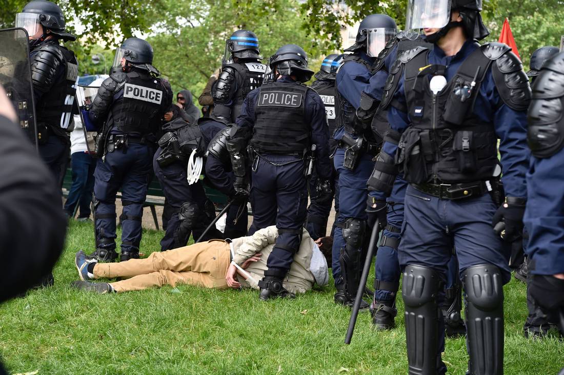 French riot police in helmets and protective gear in a park during earlier protests, file photo