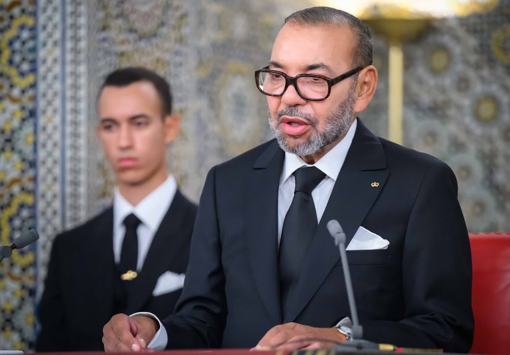 The Moroccan monarch speaks into a microphone