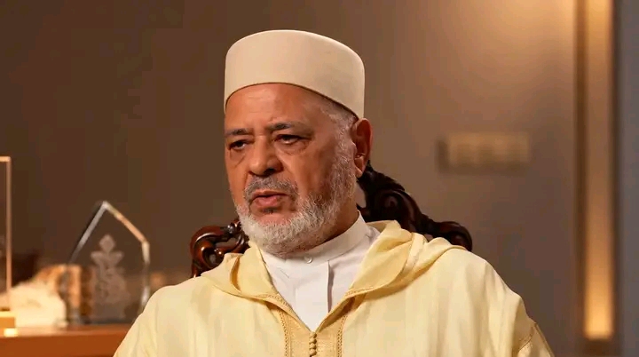 Ahmed Raissouni seated, wearing a white cap
