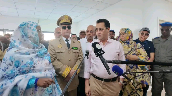 The prime minister speaking to the press during a visit to a health facility