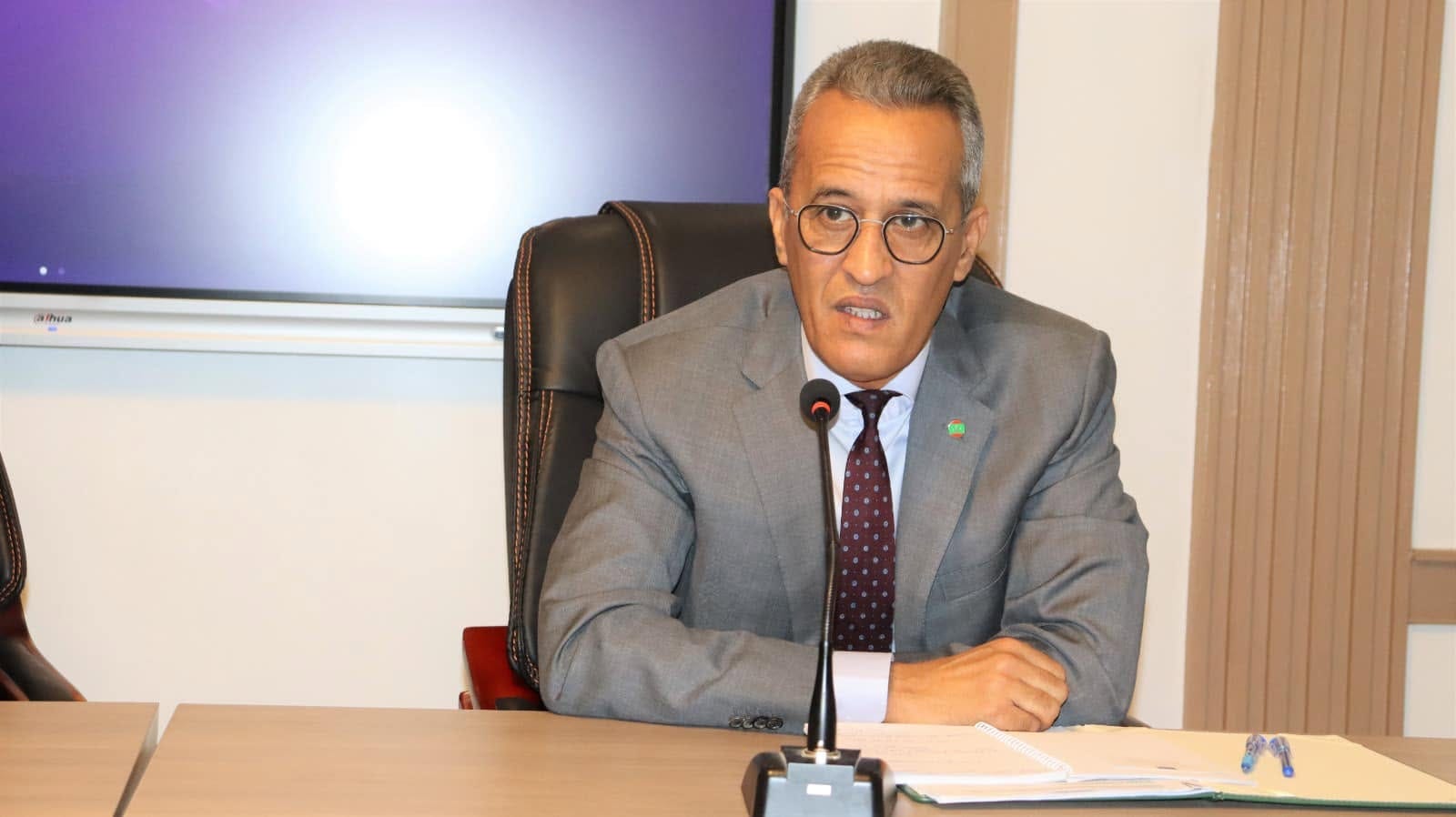The interior minister speaks at a meeting table