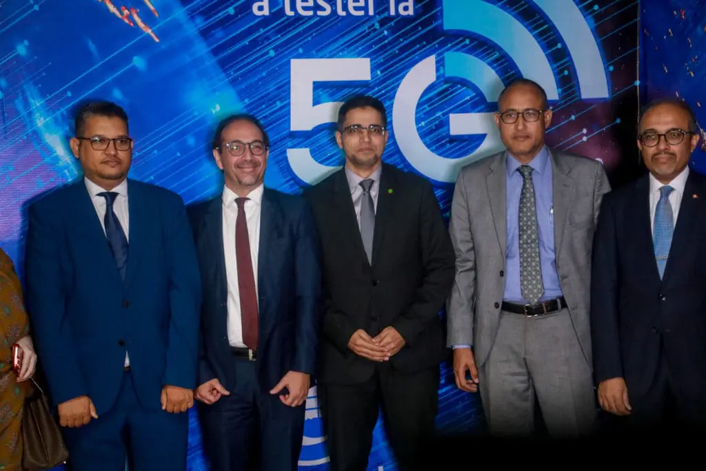 Officials stand in front of a 5G network test banner