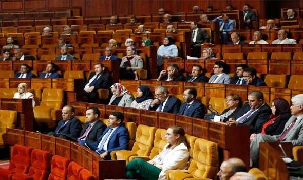 Lawmakers seated on orange benches in the chamber of Morocco's House of Representatives, file photo