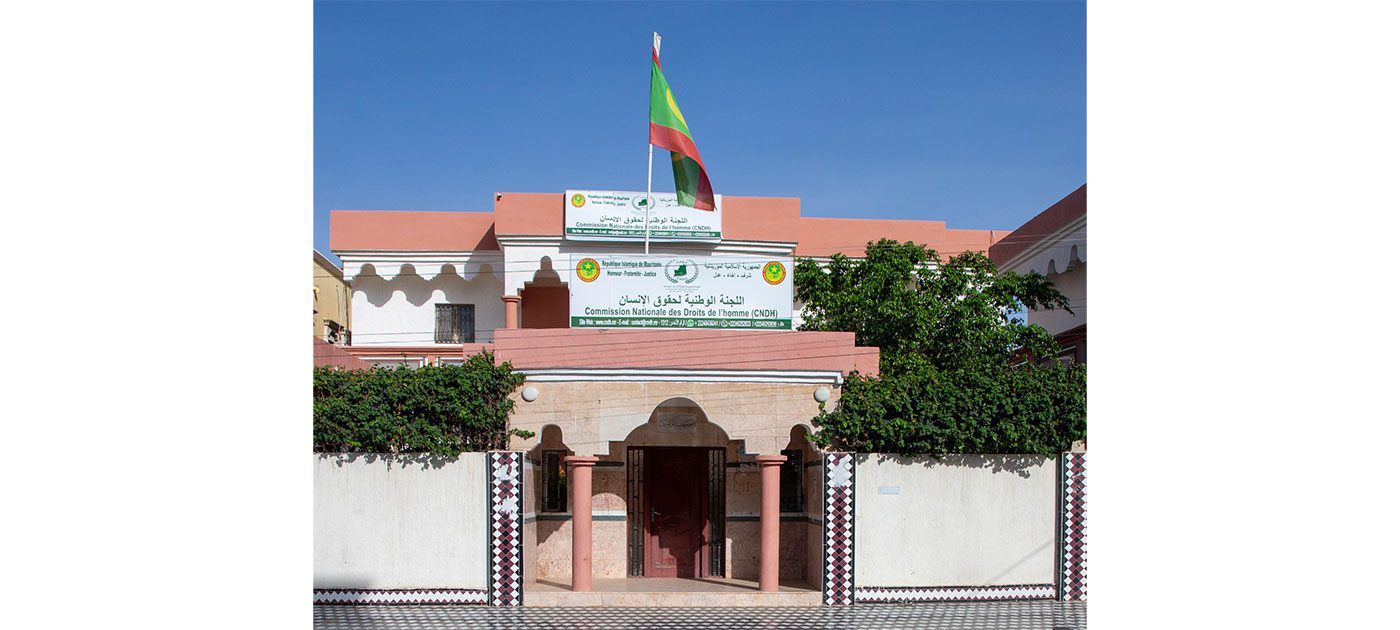 Facade of the National Human Rights Commission headquarters with its sign and the national flag