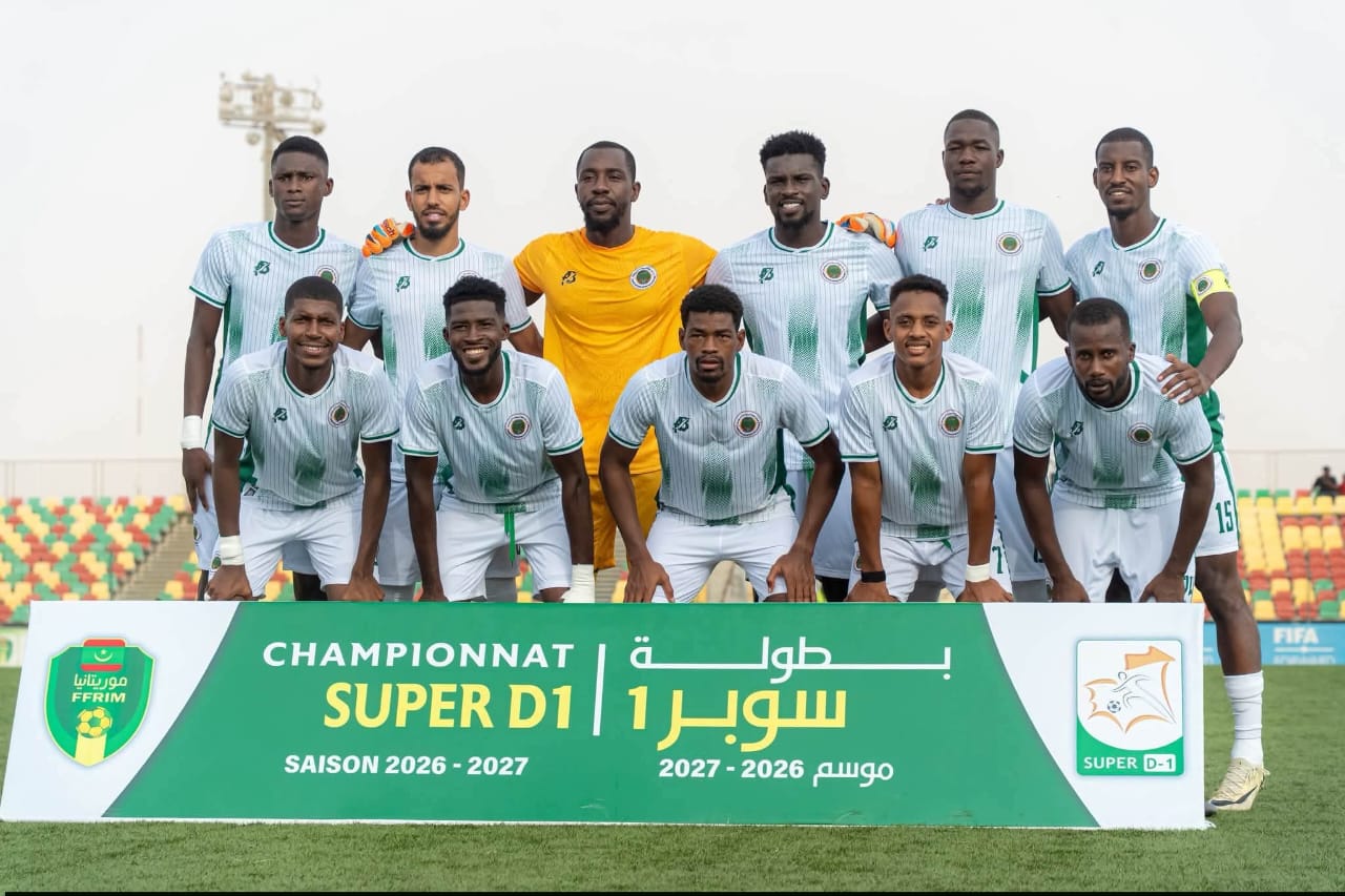 Players pose for a team photo in front of a Super D1 league banner