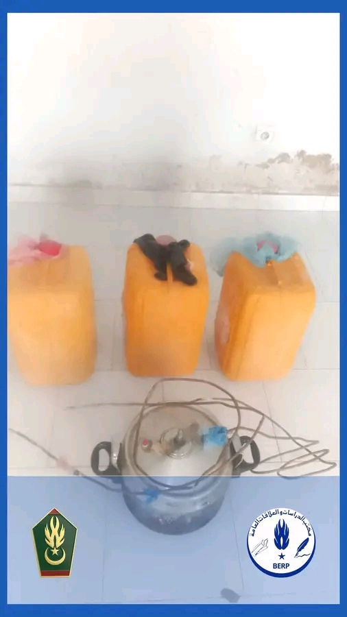 Three yellow jerrycans and a pot connected to tubing seized by the gendarmerie