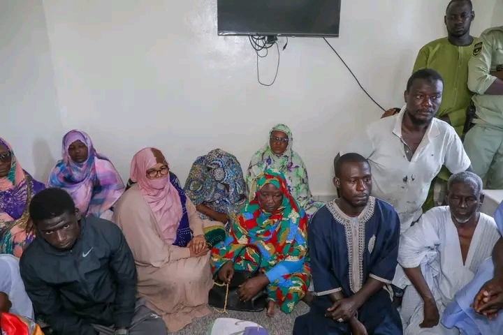 Relatives and officials seated in a room during the condolence visit