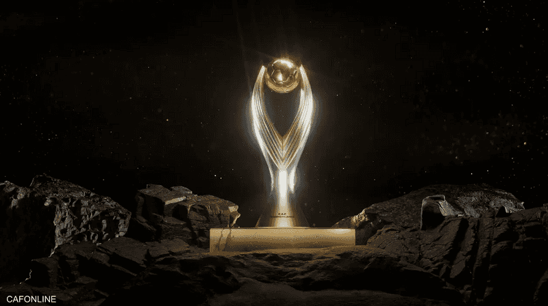 The new golden CAF Champions League trophy on a plinth among rocks against a dark background, file photo