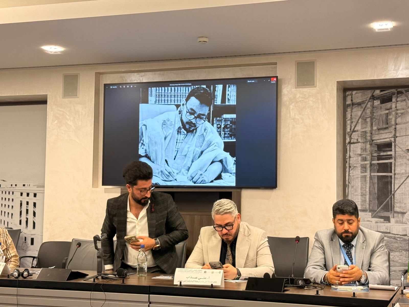 A photo of the late academic projected on a screen during a conference session in Geneva