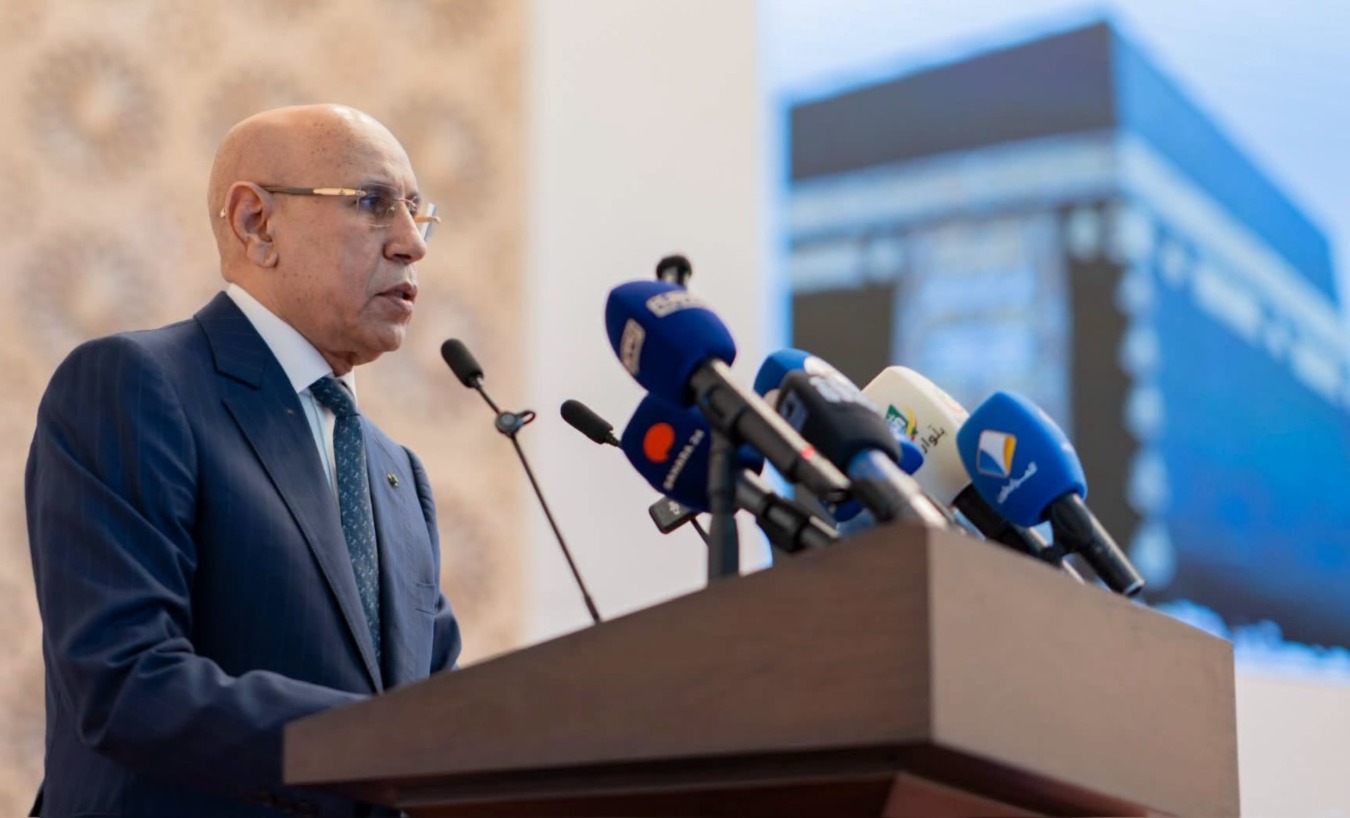 President Ghazouani speaks at a lectern in front of microphones