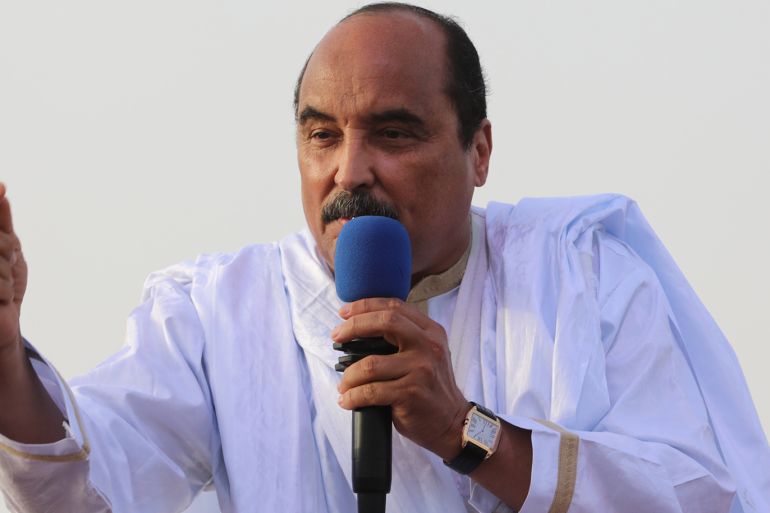 Former president Mohamed Ould Abdel Aziz speaking into a microphone