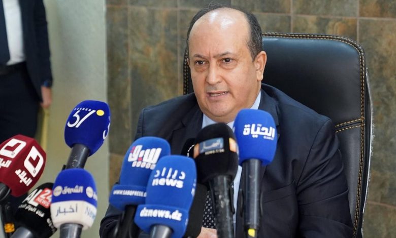 Algerian Prime Minister Sifi Ghrieb speaking in front of media microphones