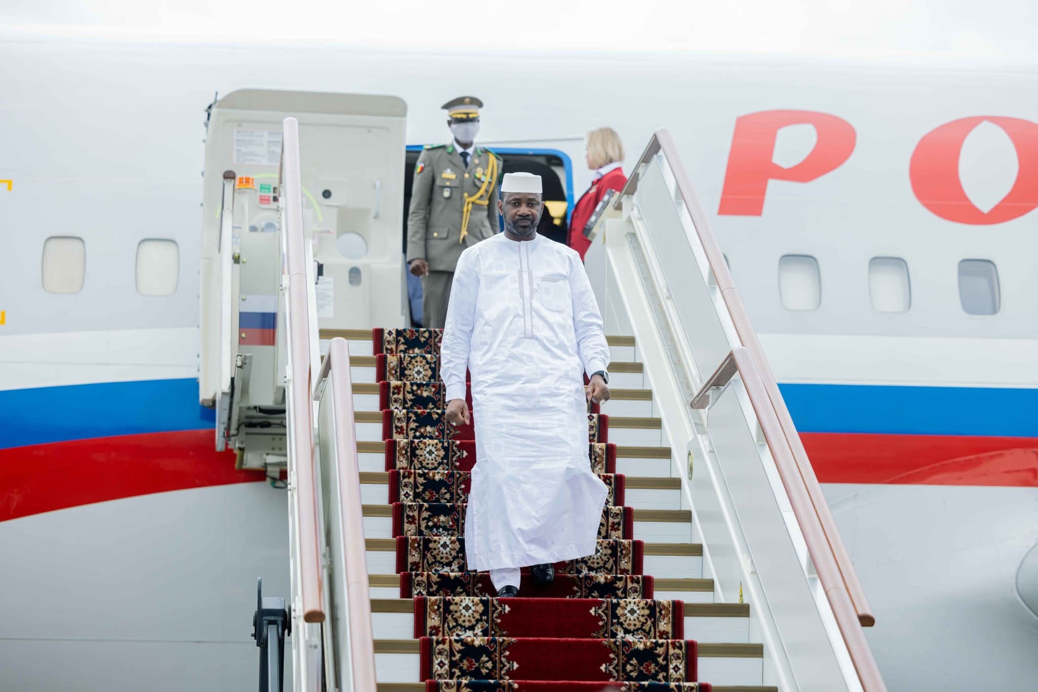 Mali's transitional president Assimi Goita, dressed in white, walks down the steps of a Russian aircraft, file photo