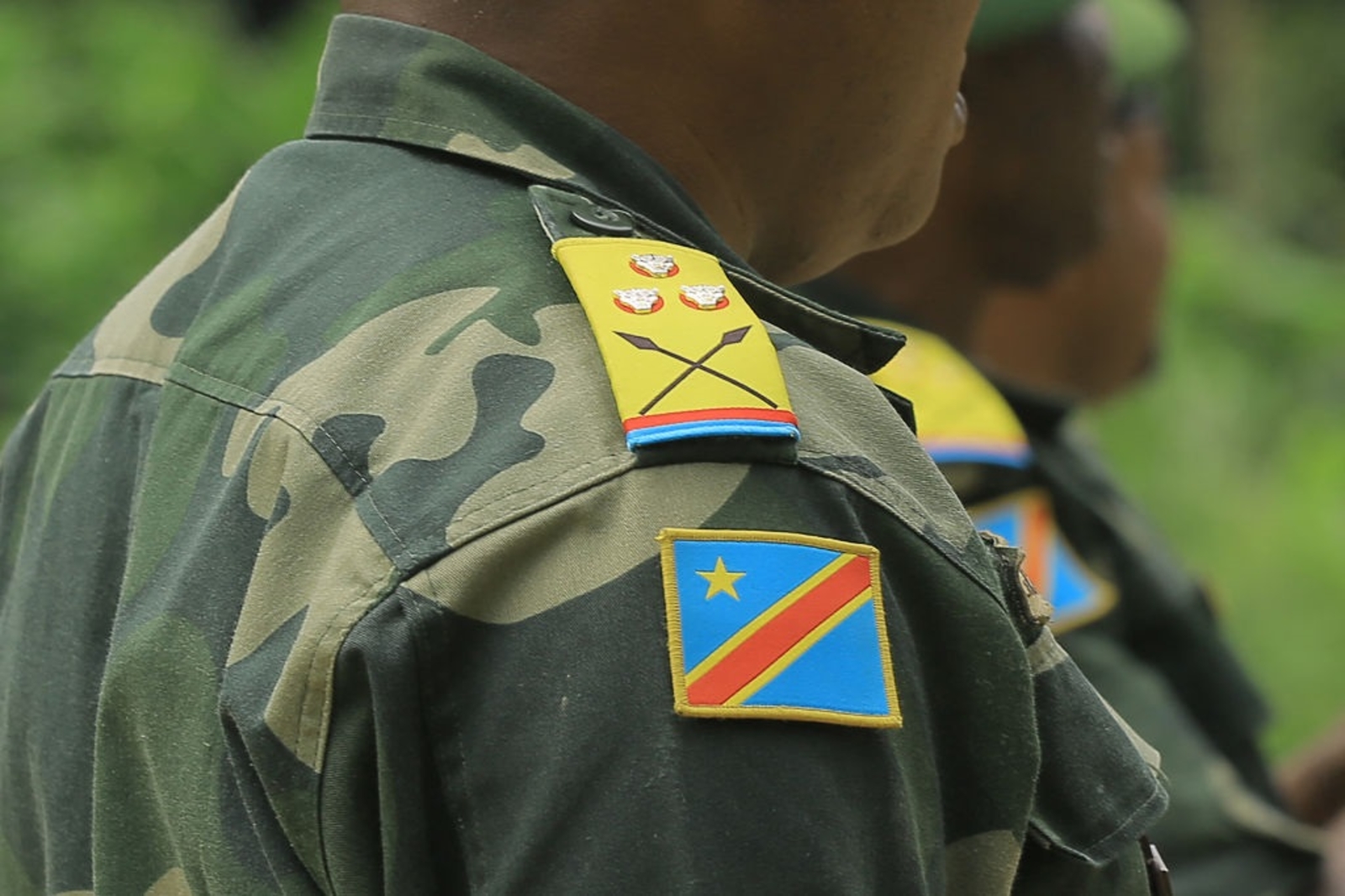 Shoulder of an officer in camouflage uniform with rank insignia and a DR Congo flag patch, file photo