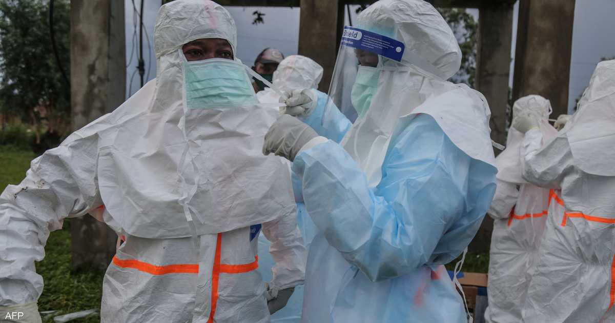 Health workers in protective suits and face shields