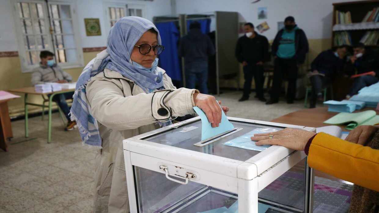 A woman casting a ballot into a transparent ballot box at a polling station in Algeria, file photo