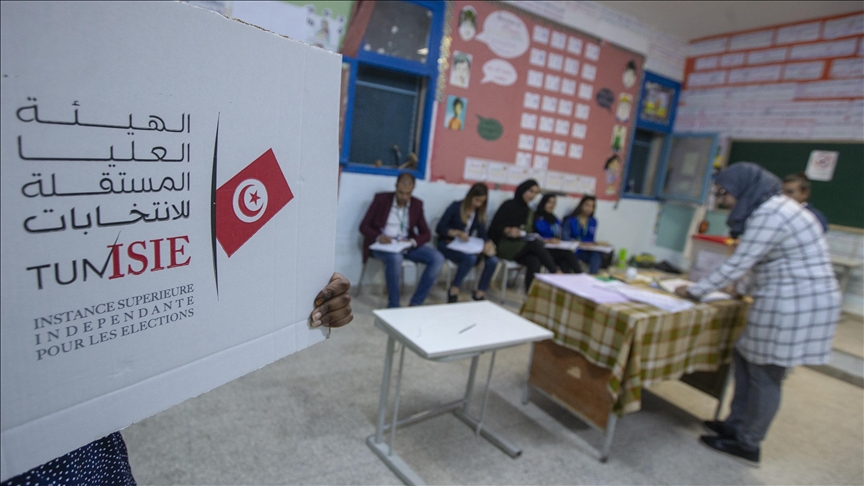 A voting booth bearing the ISIE logo and polling staff inside a classroom, file photo