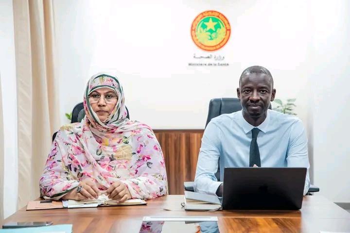 Two ministers seated at a meeting table in the Ministry of Health