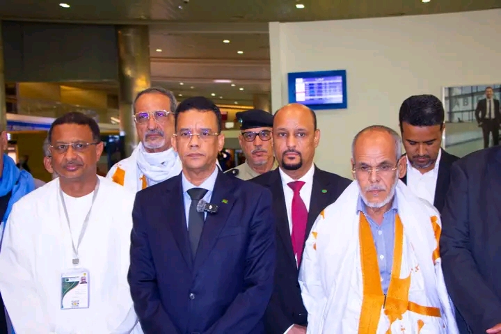 Officials and travellers inside an airport terminal