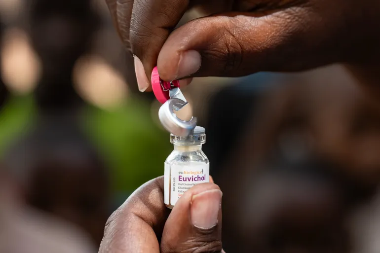 An oral cholera vaccine vial being opened