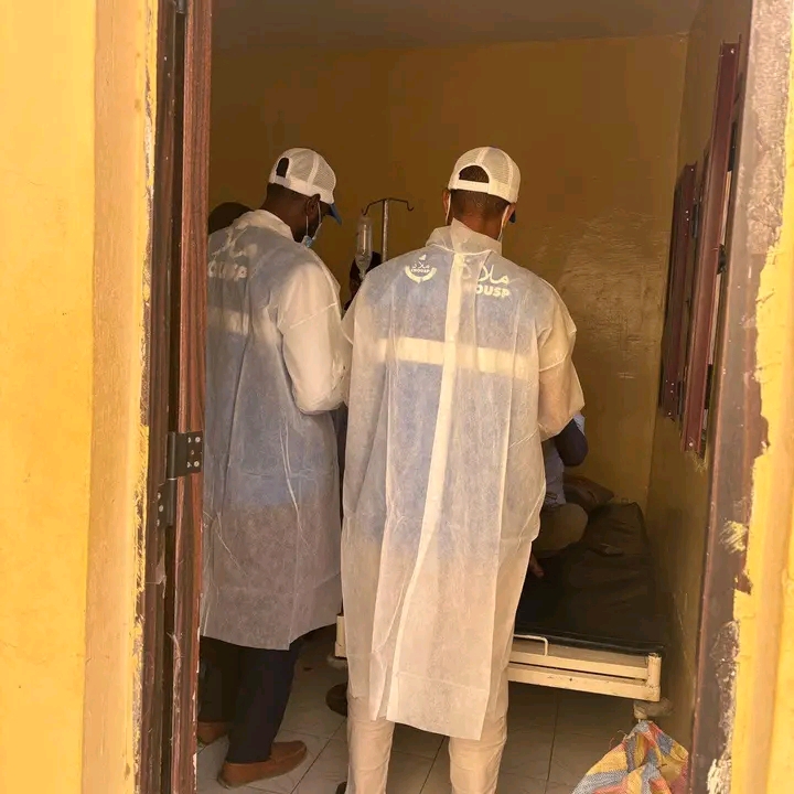 Healthcare workers wearing protective gowns inside a building