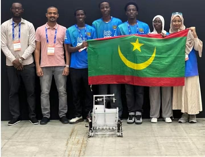 Mauritanian robotics team with the national flag and a robot